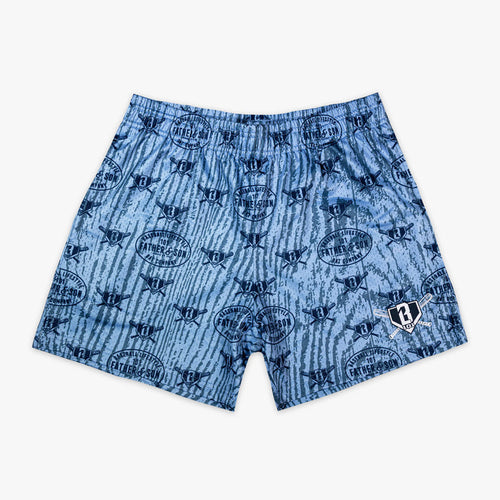 Flat lay front view of the BL101 Heritage Diamond Shorts in columbia blue featuring a wood grain camo all-over print with repeating Father & Son Bat Company oval stamps and BL101 crossed bats home plate graphics throughout.