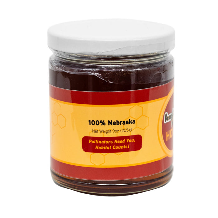 Jar of honey with a label on a white background
