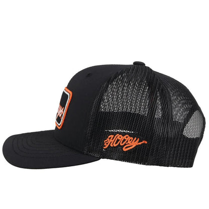 Hooey x Oklahoma State University Cowboys Black 6 panel snapback trucker cap with mesh back. Features a Cowboys patch on front and a small Hooey logo on side. Side view stock photo.