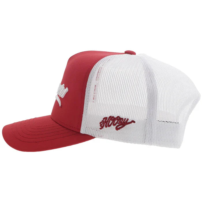 Crimson and white Snapback cap with Sooners embroidered on front with a white mesh back and Hooey logo embroidered on side. Side view stock photo showing Hooey logo.