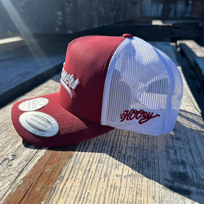 Crimson and white Snapback cap with Sooners embroidered on front with a white mesh back and Hooey logo embroidered on side. Side view