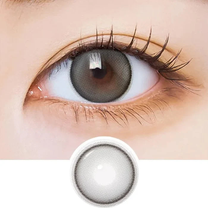 Macro shot of an eye wearing the i-Sha Dekame Hug Me Grey prescription colour contact lens, showing the multi-colored detail and natural effect on dark brown eyes, with clean eye makeup. At the bottom is the pattern of the colored lens design, showing the dotted detail and pigmentation.