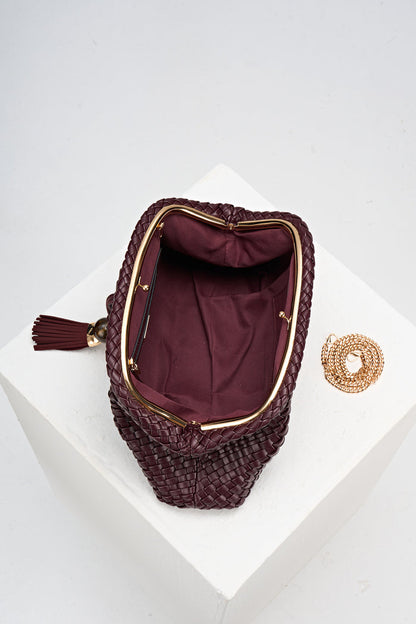 Overhead view of Indigo Black Cherry woven faux leather Oversized Clutch open showing the inside and covered gold frame clasp opening and the gold metal chain next to the bag