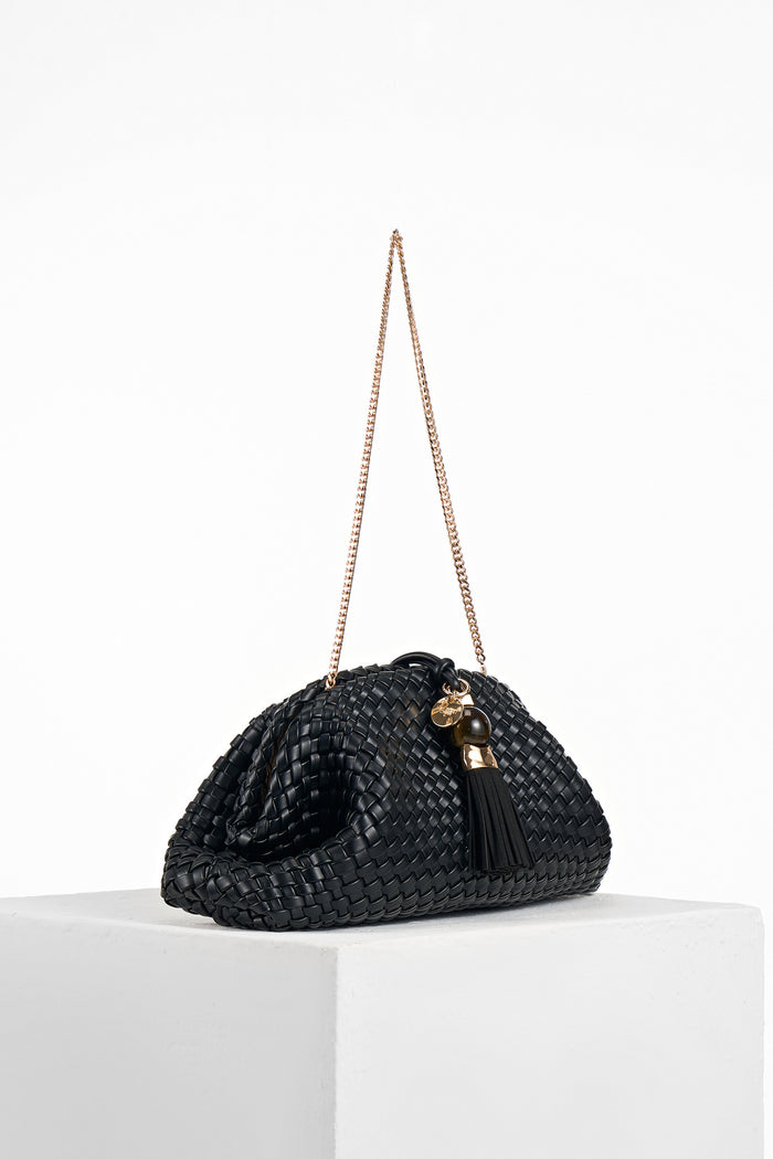 Side view of Indigo Black woven faux leather Oversized Clutch showing the gold clasp closure and detachable gold metal chain shoulder strap