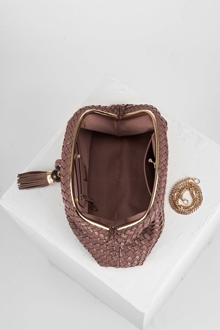 Overhead view of Indigo Pecan woven faux leather Oversized Clutch open showing the inside and covered gold frame clasp opening and the gold metal chain next to the bag