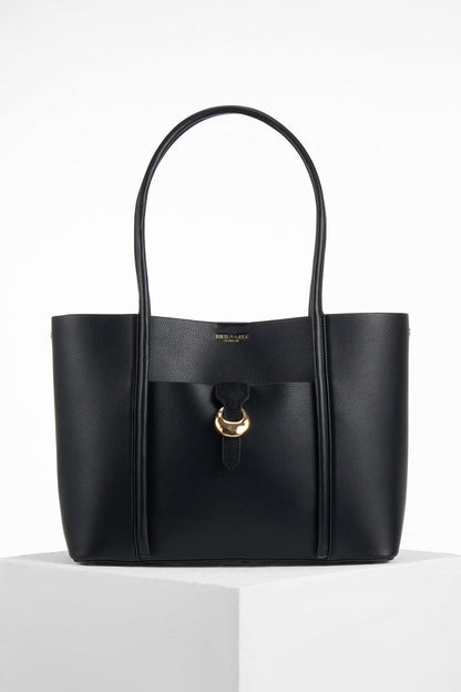 Front of Lilibet Black faux leather Laptop Tote showing molten metal Cannon Street Clasp closure on front slip-in pocket