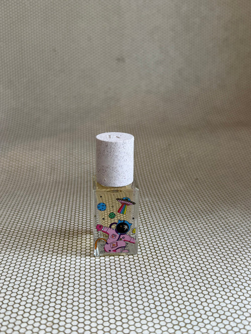 Maison Matine perfume with pink astronaut picture on glass bottle.