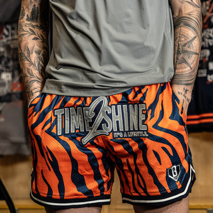 Adult model wearing orange Max Clark Tiger Court shorts