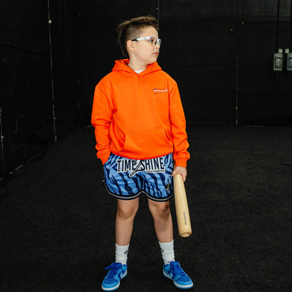 Youth model wearing blue Max Clark Tiger Court youth shorts