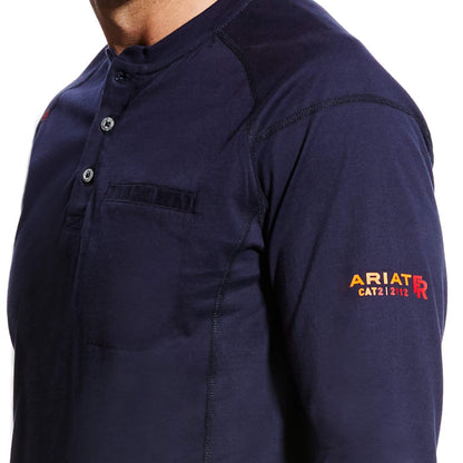 Men's Ariat FR long sleeve work shirt in Navy. Close up view of left arm showing Ariat FR CAT2 graphic print. Also shows left chest pocket.