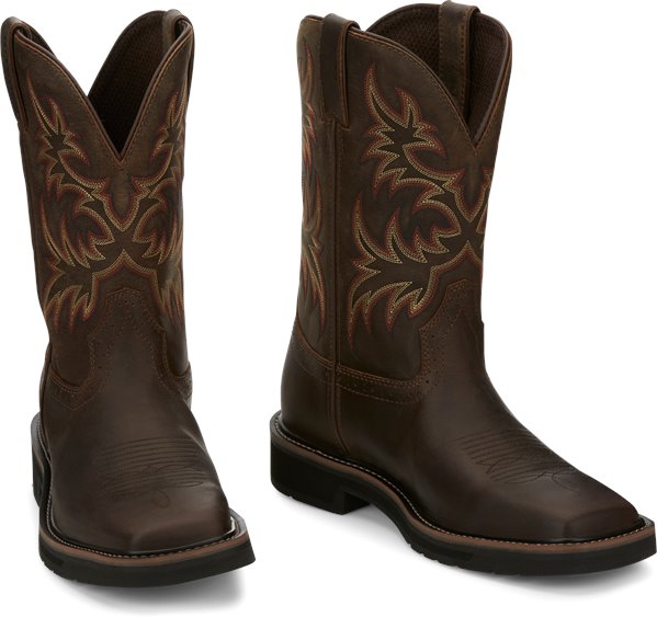 A profile view of a pair of Justin Men's Driller Brown Square Toe Work Boots with a decorative stitch pattern in Yellow and Orange on the shaft.