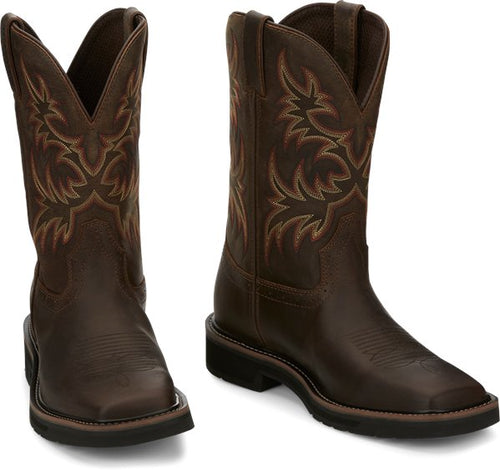 A profile view of a pair of Justin Men's Driller Brown Square Toe Work Boots with a decorative stitch pattern in Yellow and Orange on the shaft.