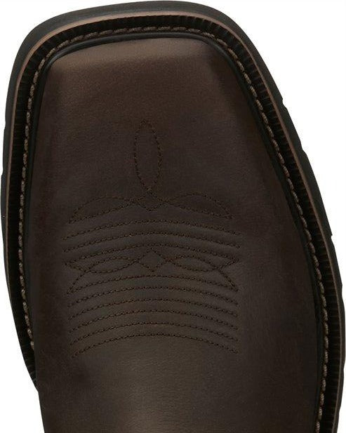 A toe view of a pair of Justin Men's Driller Brown Square Toe Work Boots.