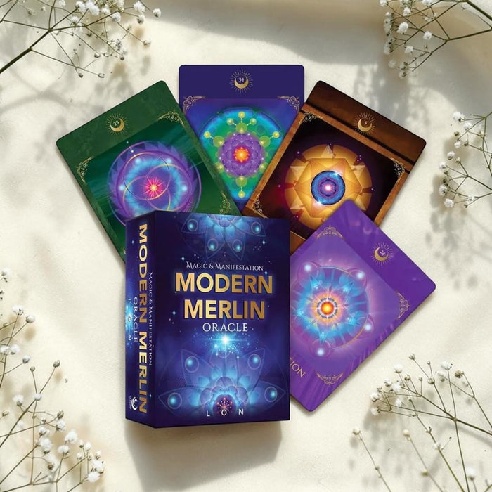 Modern Merlin Oracle cards on a light surface with white flowers