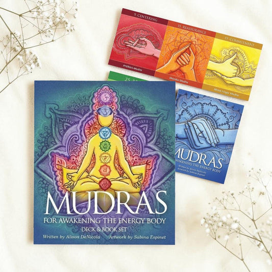 Mudras book set with colorful cards on a light background