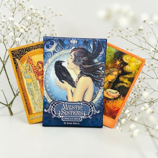 Three tarot cards from the 'Mystic Sisters' deck on a white background with decorative branches.