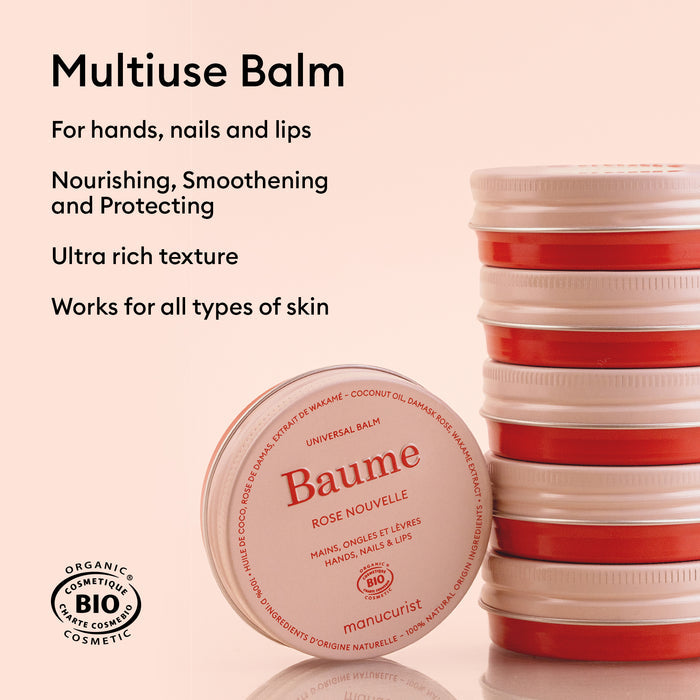 A stack of round containers with red lids and a tin of Manucurist Natural Nourishing Balm - Cosmos Organic in front. Text highlights its use on hands, nails, lips, and all skin types for natural skincare and nourishing lip repair.