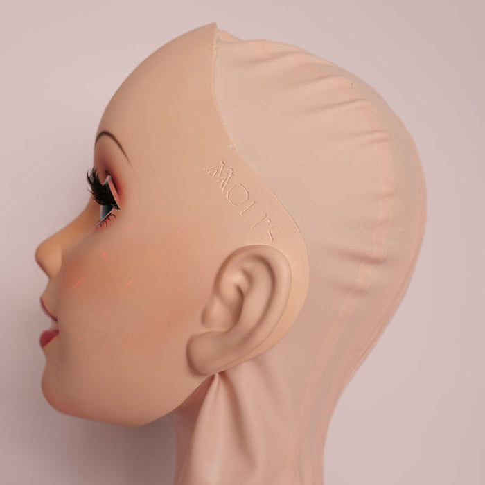 Neogan Queena female doll mask with pink latex hood and gag, by InTheMask by MOLIS, featuring detailed facial features and headgear.