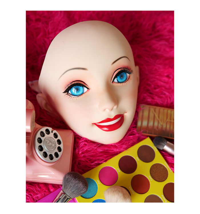 Pink latex doll mask with gag and hood by Molis D05 from InTheMask, featuring detailed female doll design and adjustable fit.
