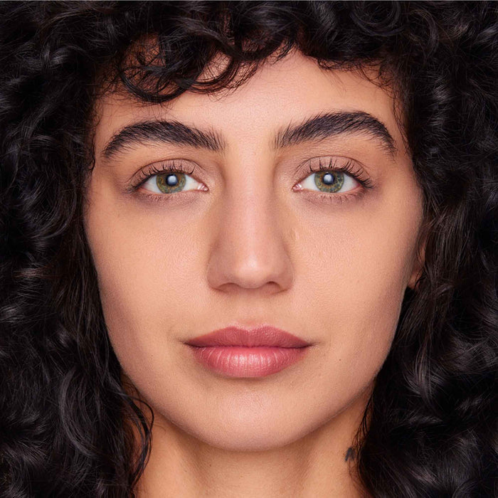 An image of a woman wearing FlexShade Foundation by No Makeup Makeup in Almond