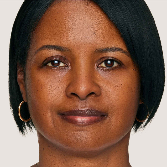 An image of a woman wearing FlexShade Foundation by No Makeup Makeup in Dark