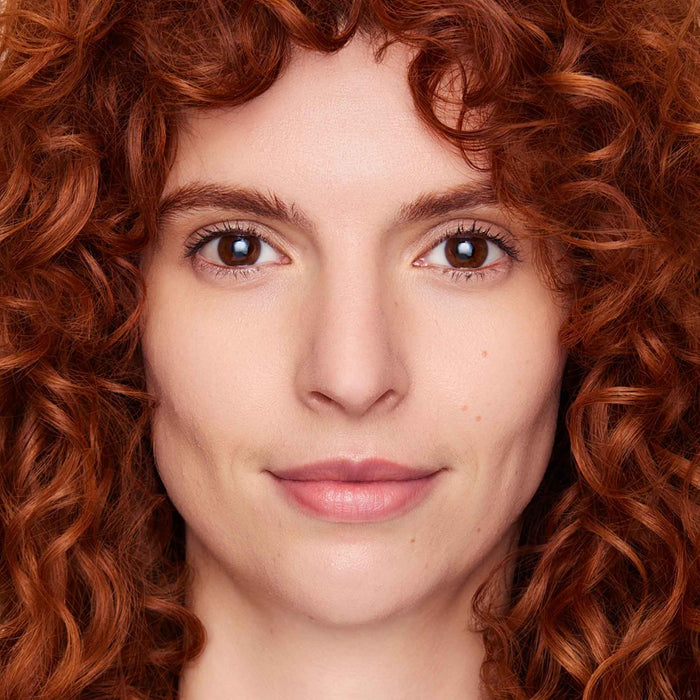 An image of a woman wearing FlexShade Foundation by No Makeup Makeup in Fair