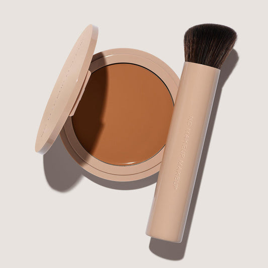 An open FlexShade Foundation by No Makeup Makeup compact in Golden Tan and a brush with the Oprah Daily Beauty O-Wards 2024 seal