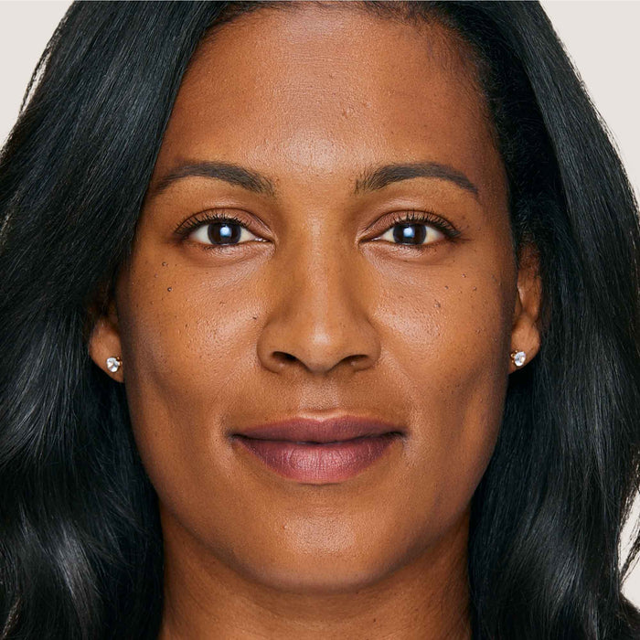 An image of a woman wearing FlexShade Foundation by No Makeup Makeup in Golden Tan