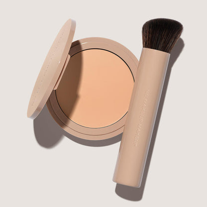 An open FlexShade Foundation by No Makeup Makeup compact in Fair and a brush