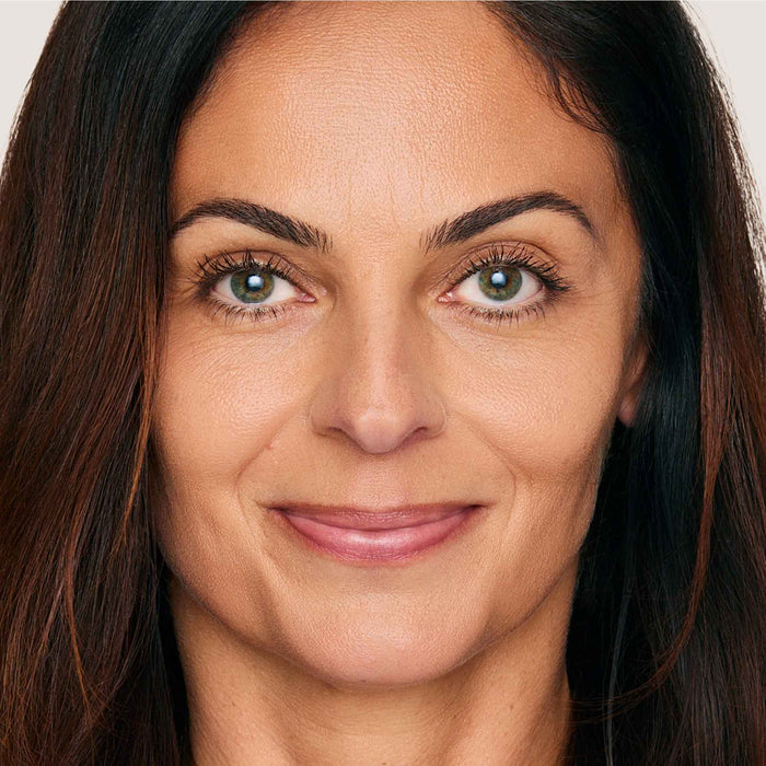 An image of a woman wearing FlexShade Foundation by No Makeup Makeup in Medium