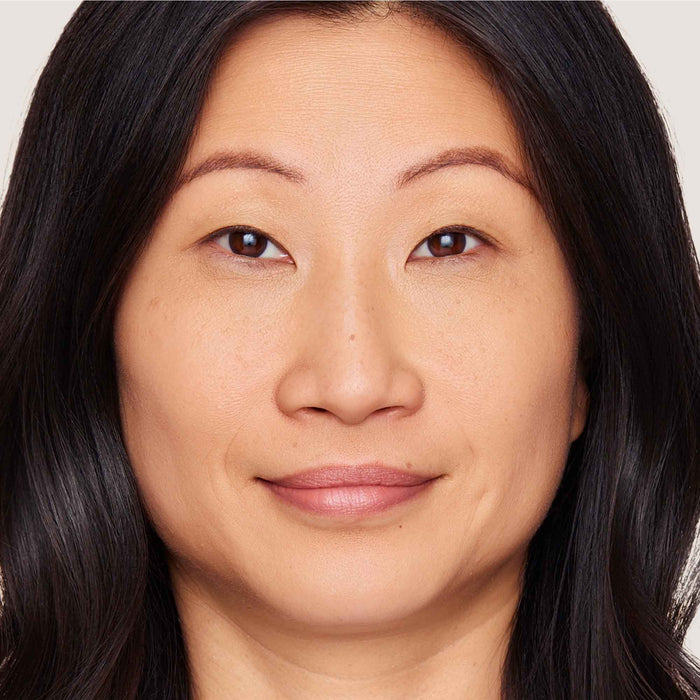 An image of a woman wearing FlexShade Foundation by No Makeup Makeup in Natural