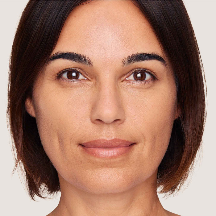 An image of a woman wearing FlexShade Foundation by No Makeup Makeup in Natural