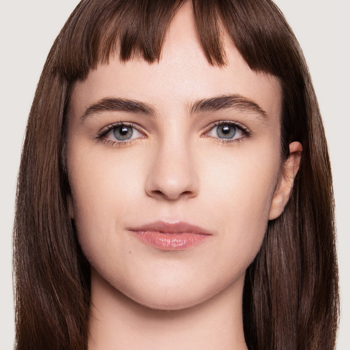 An image of a woman wearing FlexShade Foundation by No Makeup Makeup in Porcelain