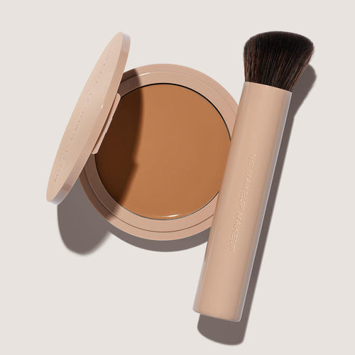 An open FlexShade Foundation by No Makeup Makeup compact in Tan and a brush with the Oprah Daily Beauty O-Wards 2024 seal