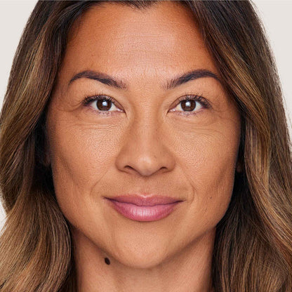 An image of a woman wearing FlexShade Foundation by No Makeup Makeup in Tan