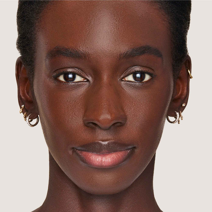 An image of a woman wearing FlexShade Foundation by No Makeup Makeup in Warm Deep