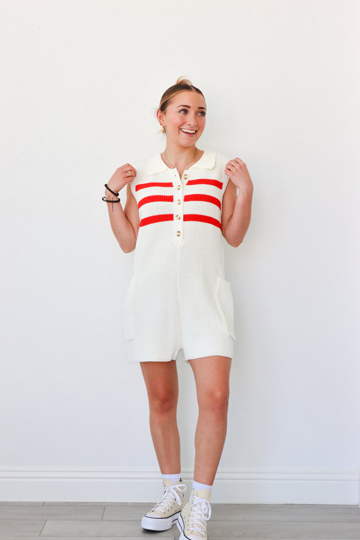 girl wearing cream and red knit short romper