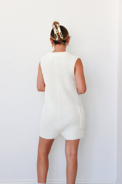 girl wearing cream and red knit short romper