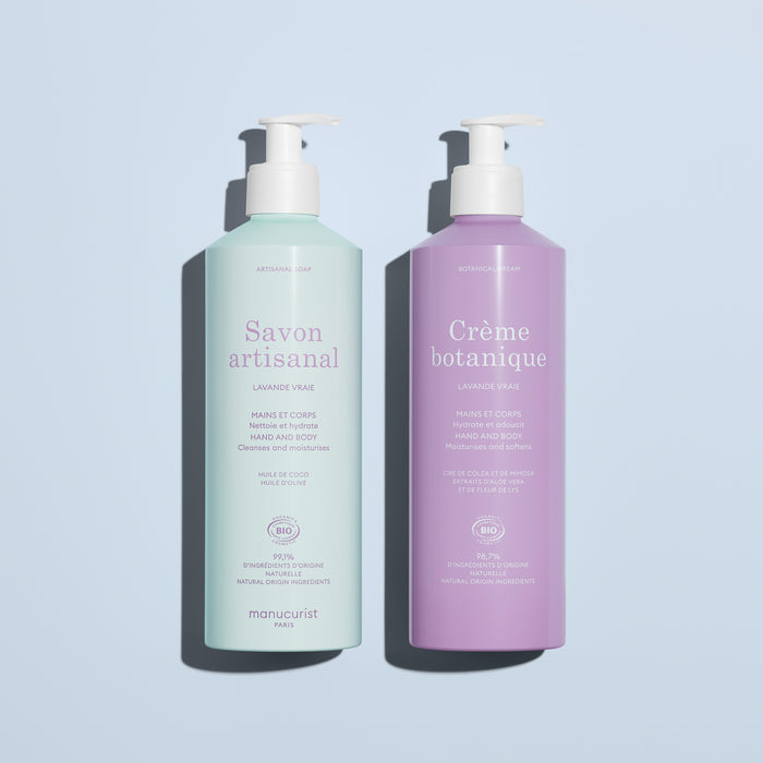 On a light blue background: two pump bottles by Manucurist, including the pale green "Artisan Soap" and the lavender "Organic Lavender Hand  Body Wash - Cosmos Organic," both for hands and body.