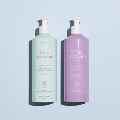 On a light blue background: two pump bottles by Manucurist, including the pale green "Artisan Soap" and the lavender "Organic Lavender Hand  Body Wash - Cosmos Organic," both for hands and body.