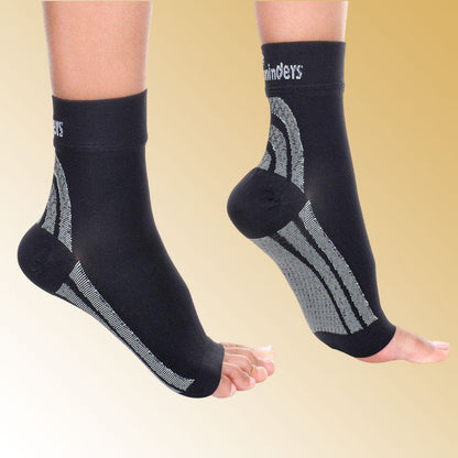 Black ankle support sleeves with visible branding on a beige background