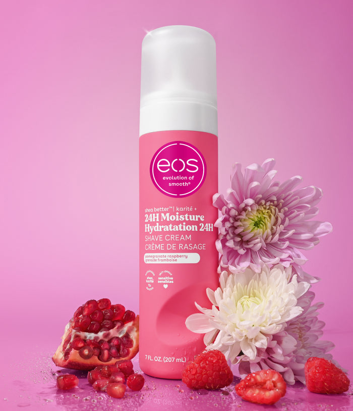 eos 24-hour moisture hydration shave cream with flowers and pomegranate on a pink background