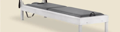 Greystone pre-stitched upholstery fitted on a Pilates Cadillac insert bed with hanging straps.
