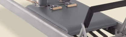 Greystone pre-stitched upholstery fitted on a Gratz Pilates reformer carriage with handles and straps.