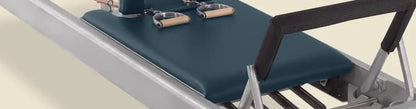 Imperial blue pre-stitched upholstery fitted on a Gratz Pilates reformer carriage.