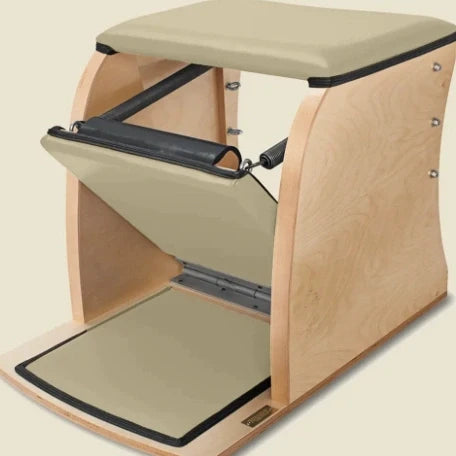 Bone pre-stitched upholstery fitted on a wooden Pilates Wunda Chair with black handle.