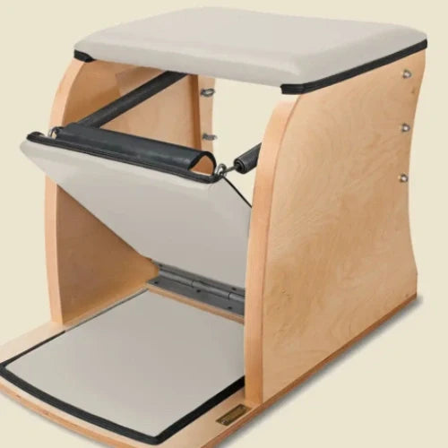 Ivory pre-stitched upholstery fitted to a wood-frame Pilates Wunda Chair with black trim.