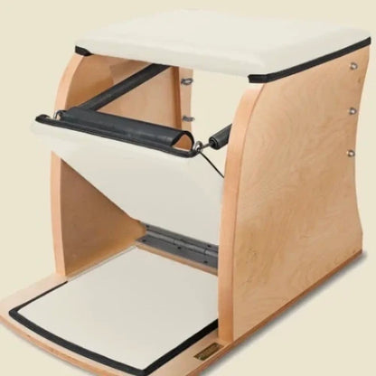 White pre-stitched upholstery fitted on a wooden Gratz Pilates Wunda Chair.