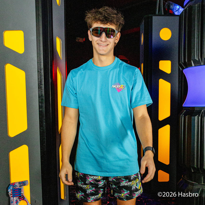 Person wearing a blue shirt and black shorts with colorful 'Nerf x BL101' logo pattern, standing in front of a black and yellow background
