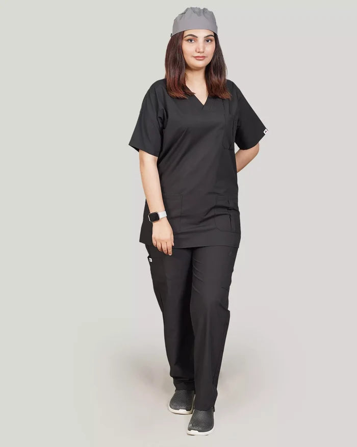 Full-body front view of a female medical professional in a stylish black Medfit unisex scrub set, complete with a matching scrub cap, ideal for modern healthcare uniforms.